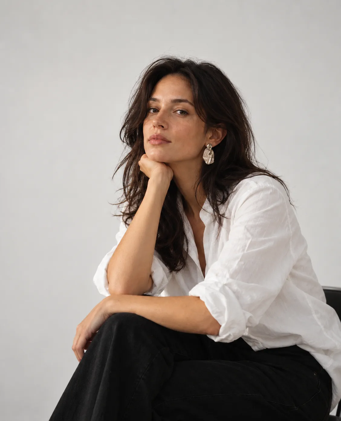 Portrait of Elena Vargas, seated, resting her chin on her hand